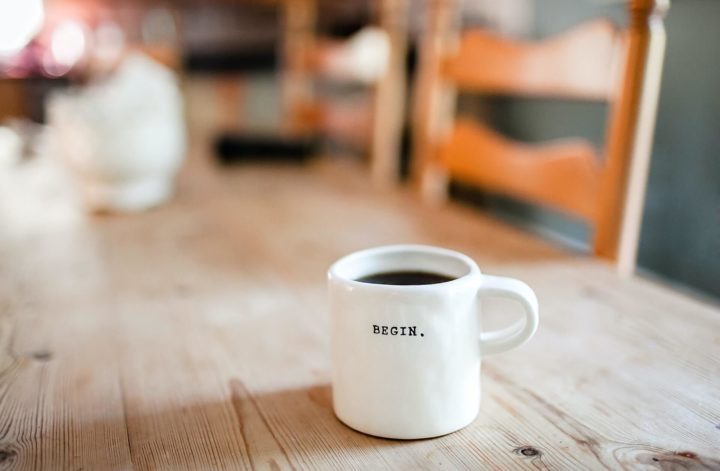 A white ceramic mug with "begin" printed on it.