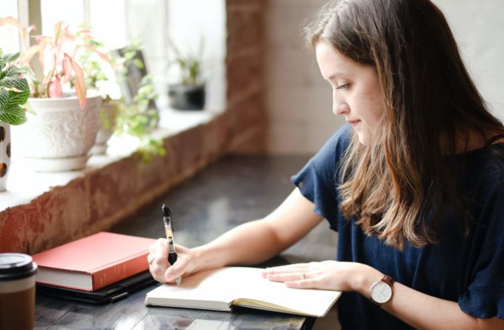 A woman writing in a journal