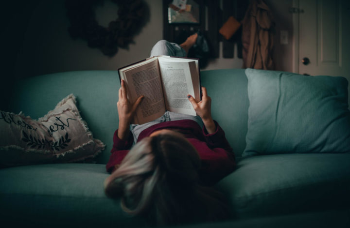 A woman reading on a couch